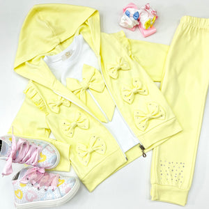 Picture of CARAMELO Yellow Tracksuit showing bows with diamanté on the hooded top and big lemon bow on the tee shirt ,this is styled with A Dee trainers