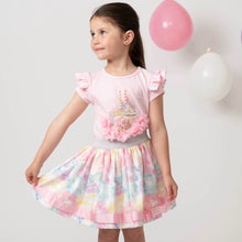 Load image into Gallery viewer, Picture of a girl wearing a Caramelo skirt set in pink which has an elasticated floral skirt with matching pink shirt sleeve tee shirt with motif of carousel horses with pearl detailing 
